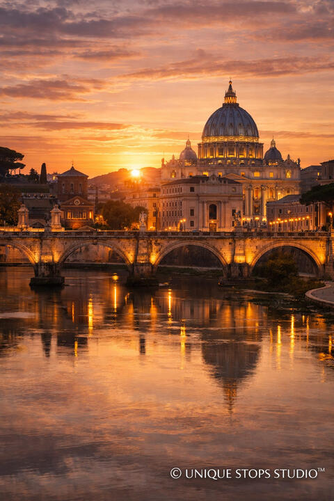 Sunset over St. Peter’s Basilica and the Tiber River in Rome, glowing reflections on the water and historic bridge — premium cinematic travel photography licensed by Unique Stops Studio™ for film, advertising, and global brand campaigns.